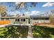 Inviting front exterior of home with solar panels, landscaping and walkway at 863 S Dudley St, Lakewood, CO 80226