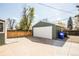 View of the detached two-car garage, concrete driveway, and fenced yard at 863 S Dudley St, Lakewood, CO 80226
