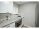 Close-up of bright, updated kitchen featuring granite countertops and white cabinetry at 863 S Dudley St, Lakewood, CO 80226