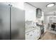 Modern kitchen featuring stainless steel appliances, granite countertops, and white cabinetry at 863 S Dudley St, Lakewood, CO 80226