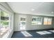 Bright sunroom featuring large windows and a view of the green backyard at 863 S Dudley St, Lakewood, CO 80226