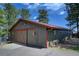 Rustic barn with sliding wood doors and painted trim offers storage and character at 207 County Road 65, Evergreen, CO 80439