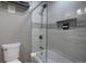 Modern bathroom featuring gray tiled shower, built-in niche, and a sleek glass door at 207 County Road 65, Evergreen, CO 80439