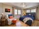 Bedroom with hardwood floors, natural light, and a comfortable sitting area at 207 County Road 65, Evergreen, CO 80439