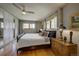 Bedroom with hardwood floors, fan, ample natural light, and large closet at 207 County Road 65, Evergreen, CO 80439