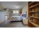 Bedroom with a built-in dresser, hardwood floors, window and decorative quilts and pillows on the bed at 207 County Road 65, Evergreen, CO 80439