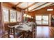 Inviting dining room with natural light, a wooden table set for six, and sliding glass doors leading to an outdoor space at 207 County Road 65, Evergreen, CO 80439