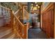 Inviting entryway with wood stairs, slate flooring, and a unique light fixture at 207 County Road 65, Evergreen, CO 80439