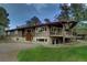 Charming, unique home showcasing a harmonious blend of stone and wood accents, complemented by a spacious driveway at 207 County Road 65, Evergreen, CO 80439