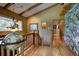 Hallway with vaulted ceilings, wood floors, and a decorative chandelier at 207 County Road 65, Evergreen, CO 80439