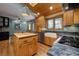 Bright kitchen featuring custom wood cabinets, granite countertops, stainless steel appliances and farm style sink at 207 County Road 65, Evergreen, CO 80439