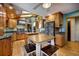 Bright kitchen featuring custom wood cabinets, granite countertops, stainless steel appliances and eat-in table at 207 County Road 65, Evergreen, CO 80439