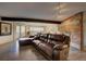 Spacious living room with a leather sectional and a brick fireplace at 207 County Road 65, Evergreen, CO 80439