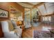 Open living space with stone fireplace, vaulted ceilings, and an adjacent dining area at 207 County Road 65, Evergreen, CO 80439