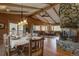 Inviting dining and living room featuring a stone fireplace, a table set for six, and comfortable seating at 207 County Road 65, Evergreen, CO 80439