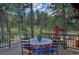 Cozy outdoor dining area with a colorful tablecloth, surrounded by lush greenery and trees at 207 County Road 65, Evergreen, CO 80439