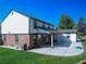 Exterior view of home with lush green grass and covered patio area at 9451 W Hialeah Pl, Littleton, CO 80123