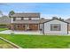 A spacious backyard featuring a covered patio and a well-maintained lawn perfect for outdoor activities at 9451 W Hialeah Pl, Littleton, CO 80123