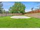 Spacious backyard with a well-maintained lawn and a basketball court at 9451 W Hialeah Pl, Littleton, CO 80123
