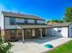 Exterior of home showcasing a covered patio and spacious yard, perfect for entertaining at 9451 W Hialeah Pl, Littleton, CO 80123