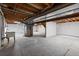 Spacious unfinished basement offering ample storage and utility connections at 9451 W Hialeah Pl, Littleton, CO 80123