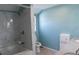 Bathroom featuring white marble shower and tub and a large light blue wall at 9451 W Hialeah Pl, Littleton, CO 80123