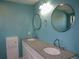 Bathroom with double sinks, granite countertop, and modern fixtures at 9451 W Hialeah Pl, Littleton, CO 80123