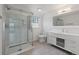 Modern bathroom featuring a sleek glass shower, contemporary vanity, and stylish tile flooring at 9451 W Hialeah Pl, Littleton, CO 80123
