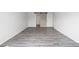 Spacious bedroom with stylish sliding barn door and laminate flooring, creating a warm and inviting atmosphere at 9451 W Hialeah Pl, Littleton, CO 80123