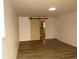 Bedroom with wood-look floors and a barn door adding a touch of rustic charm at 9451 W Hialeah Pl, Littleton, CO 80123