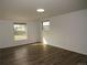 Bright bedroom with ample natural light, wood-look flooring, and fresh neutral walls at 9451 W Hialeah Pl, Littleton, CO 80123