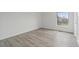 Bright, airy bedroom with laminate flooring and a large window, creating a peaceful and relaxing retreat at 9451 W Hialeah Pl, Littleton, CO 80123