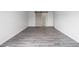 Bright bedroom with a stylish sliding barn door that leads to bathroom, and modern laminate flooring at 9451 W Hialeah Pl, Littleton, CO 80123