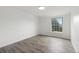 Bright bedroom features wood floors and a window providing natural light at 9451 W Hialeah Pl, Littleton, CO 80123