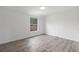 Bedroom features wood floors and a window providing natural light at 9451 W Hialeah Pl, Littleton, CO 80123