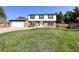 Landscaped, two-story home with a lawn, driveway, and two-car garage at 9451 W Hialeah Pl, Littleton, CO 80123