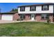 Two-story home on a manicured lawn, with a driveway leading to a two-car garage at 9451 W Hialeah Pl, Littleton, CO 80123
