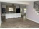 Modern kitchen with white cabinets, black countertops, stainless steel appliances and a view to the living room at 9451 W Hialeah Pl, Littleton, CO 80123