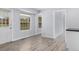 Bright and airy kitchen featuring new modern flooring and a view to the outdoors at 9451 W Hialeah Pl, Littleton, CO 80123