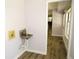 Well-lit laundry room featuring a utility sink and durable, wood-look flooring at 9451 W Hialeah Pl, Littleton, CO 80123