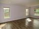 Large living room featuring wood-look floors and a lot of natural light at 9451 W Hialeah Pl, Littleton, CO 80123