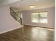 Open living room featuring wood-look floors, modern railing and a large window at 9451 W Hialeah Pl, Littleton, CO 80123