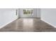 Spacious room featuring light gray walls, white trim, and durable wood-look flooring at 9451 W Hialeah Pl, Littleton, CO 80123