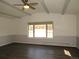 Spacious living room with exposed beam ceiling and large bright window at 9451 W Hialeah Pl, Littleton, CO 80123
