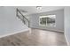 Bright living room with large windows, wood floors and staircase with metal railing at 9451 W Hialeah Pl, Littleton, CO 80123