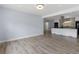 Bright room with wood floors looking into the kitchen and entryway at 9451 W Hialeah Pl, Littleton, CO 80123