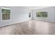 Bright and open room with large windows, light gray walls, and modern, gray-toned flooring at 9451 W Hialeah Pl, Littleton, CO 80123