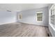 Bright living room with large windows, neutral walls, and light-colored wood flooring at 9451 W Hialeah Pl, Littleton, CO 80123