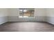 Well-lit room with durable gray floors and a large window bringing light into this inviting space at 9451 W Hialeah Pl, Littleton, CO 80123