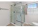 Modern bathroom featuring a spacious glass enclosed shower with white marbled tile surround at 9451 W Hialeah Pl, Littleton, CO 80123